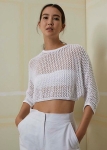 Model wearing cropped, knitted, white mesh sweater with oversized fit and 3/4 sleeves. Knitting pattern by LangYarns Switzerland.