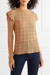Model wearing knitted, biscuit coloured jumper with pointelle grid front and crochet ruffles at neck and shoulder.