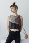 Woman wearing cropped, oversized knitted top with abstract shape intarsia motifs in grey, brown and black, inspired by the work of Helen Frankenthaler.