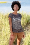 Model wearing knitted cotton, mesh top over shorts on a summer day.