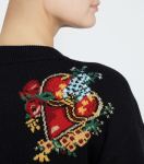Close up of model wearing sweater from Dolce & Gabbana with heart and floral motifs