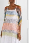 Model wearing Missoni oversized, multicoloured, knitted top with mesh fabric, worn over white dress.