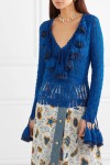 Deep blue, knitted cotton cardigan with lace details at hem and along arms and with oversized tassels edging v-neck collar.